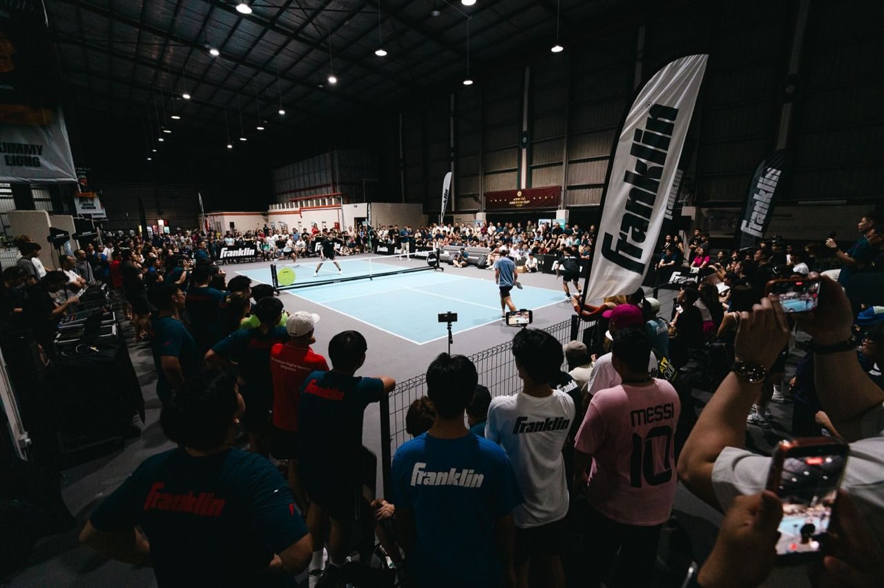 A packed crowd watching a live pickleball match at ATP Club